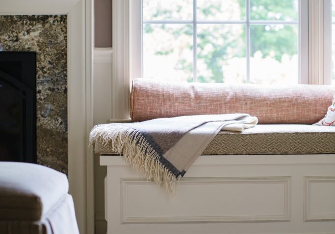 Transitional windowsill bench with white molding and beige cushion